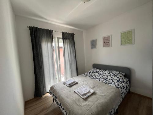 a bedroom with a bed and a window at Villa Marija in Crikvenica