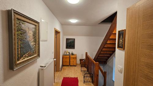 a hallway with stairs and a painting on the wall at Apartma Sava-Stol in Jesenice