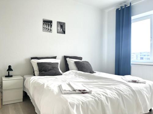 a bedroom with a bed with white sheets and a window at Newly Renovated Apartment With 1 Bedroom In Kolding in Kolding