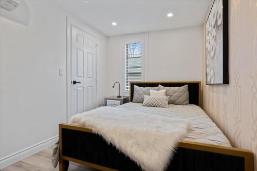 a bedroom with a large bed with a blanket on it at Luxe Lodges on Lake Erie in Port Dover