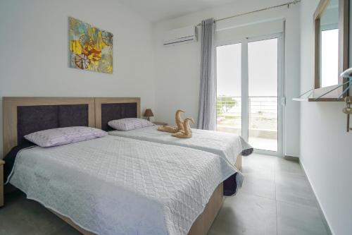a bedroom with a bed with a teddy bear on it at Sunshine House Kos - Easy living by the sea in Kefalos