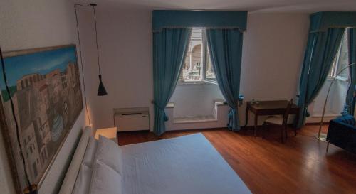 a bedroom with a bed and a large window at Umbrian Concierge - Duomo Accommodations in Perugia