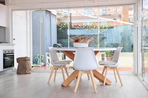 a dining room with a table and chairs at Terrazza Paradiso Luxury Rooftop in Naples
