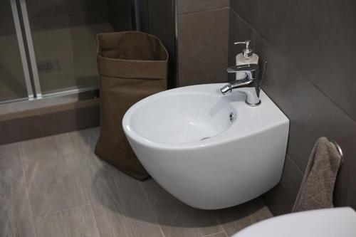 a bathroom with a white sink and a shower at Terrazza Paradiso Luxury Rooftop in Naples