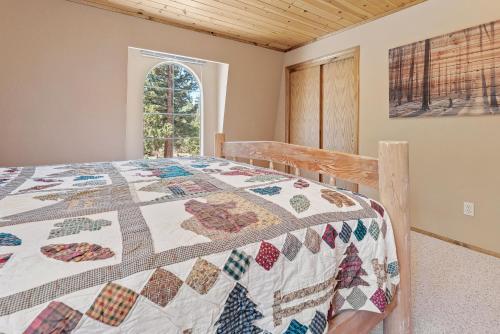 a bedroom with a bed with a quilt on it at Hikers Haven -Only steps to the National Forest and trails! in Big Bear City