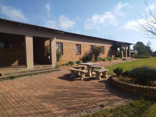 a brick building with a picnic table in front of it at KUNGWINI CENTER in Bronkhorstspruit