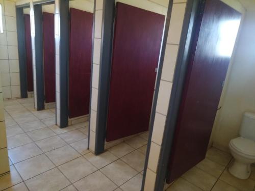 a row of stalls in a bathroom with a toilet at KUNGWINI CENTER in Bronkhorstspruit
