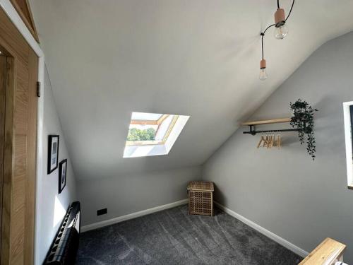 a attic room with a skylight and a window at The Annex Glastonbury Tor View in Glastonbury
