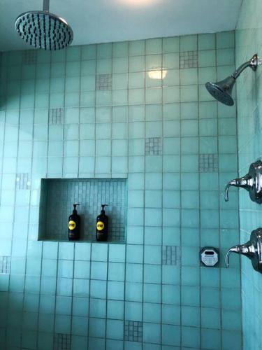 a bathroom with two bottles of soap in a mirror at 5-star Luxury Apartment - Atop the Seagle Building in Gainesville
