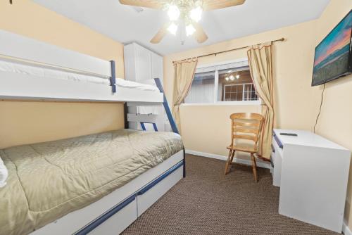 a bedroom with a bunk bed and a chair at Irie's Retreat - Perfect location for multi-generational groups! Sauna, hot tub, Jungle gym! in Sugarloaf