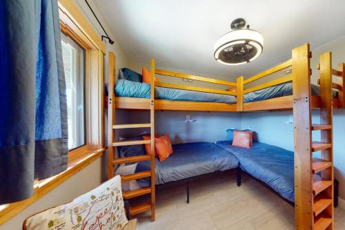 a room with three bunk beds and a couch at Ridgeline Panorama in Truckee