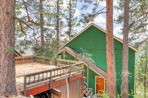 a green house with a deck in the woods at Ridgeline Panorama in Truckee