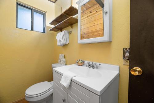 a bathroom with a white sink and a toilet at Comfy Cubby - Cozy mountain home in a great location near Bear Mountain Ski Resort in Big Bear Lake
