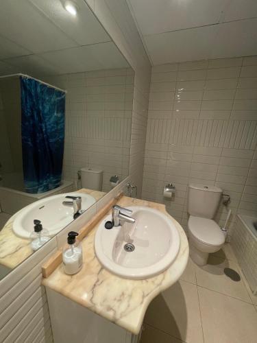 a bathroom with a sink and a toilet and a mirror at Apto One More Day in Ambar in Calpe