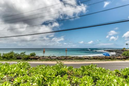 a view of the ocean from a road at Manualoha 203 in Koloa