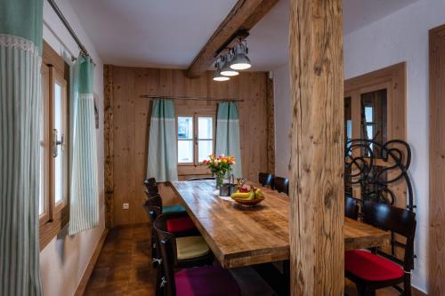 a dining room with a wooden table and chairs at Chalupa Bocza in Nižná Boca