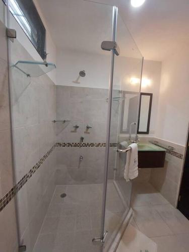 a bathroom with a shower and a glass shower stall at Villas Cozumel #9 in Cozumel