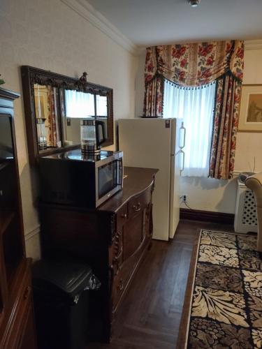 a kitchen with a microwave on top of a dresser at The King George Inn in Cobourg
