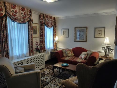 a living room with two chairs and a couch at The King George Inn in Cobourg