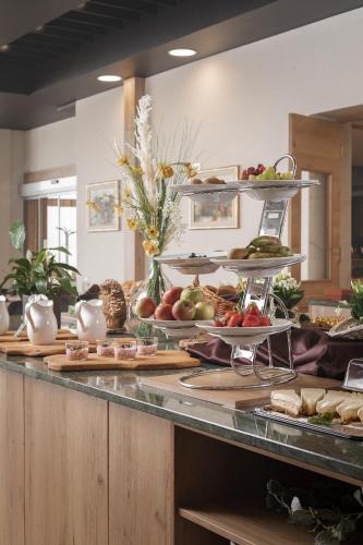 a buffet with many plates of food on a counter at Grand Hotel BELLEVUE in Pohorje