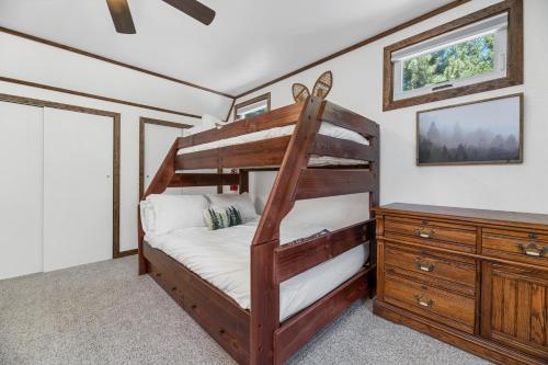 a bedroom with a bunk bed and a dresser at Little Bear Cottage - Cozy, quaint cabin with a great fireplace and so many fun board games! in Big Bear Lake
