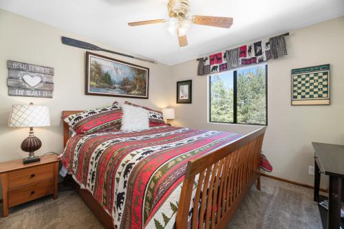 een slaapkamer met een bed en een plafondventilator bij Edventures Await - Beautifully updated mountain home with billiards and hot tub! in Big Bear Lake