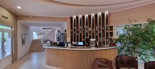 a lobby with a bar with chairs and a staircase at Vila Dincic doo in Veliko Gradište
