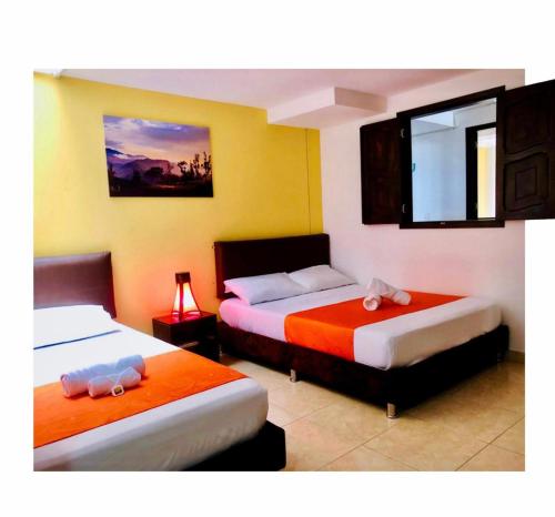 a bedroom with two beds with towels on them at HOTEL SHAMBALA in Salento