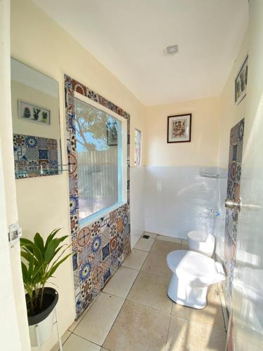 a bathroom with a toilet and a glass shower at Tanay Panoramic Mountain View Cabin 