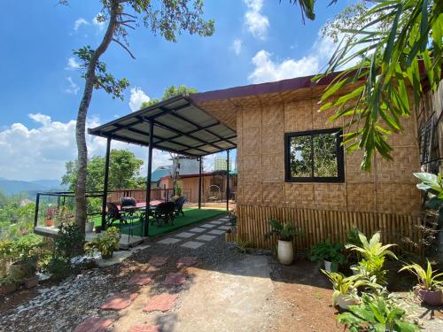 a small house with a large roof at Tanay Panoramic Mountain View Cabin 