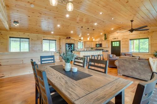 a dining room and living room with a wooden ceiling at Gorgeous Gatlinburg Cabin Large Deck and Hot Tub! in Gatlinburg