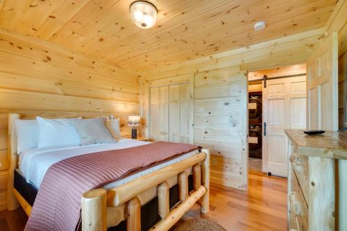 a bedroom with a bed in a log cabin at Gorgeous Gatlinburg Cabin Large Deck and Hot Tub! in Gatlinburg