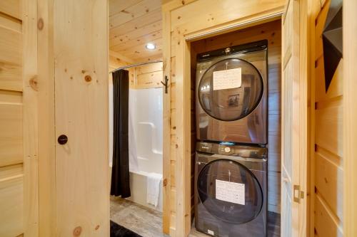 a washer and dryer in a room with a bathroom at Gorgeous Gatlinburg Cabin Large Deck and Hot Tub! in Gatlinburg