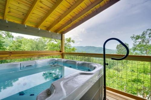 a hot tub on a deck with a view at Gorgeous Gatlinburg Cabin Large Deck and Hot Tub! in Gatlinburg