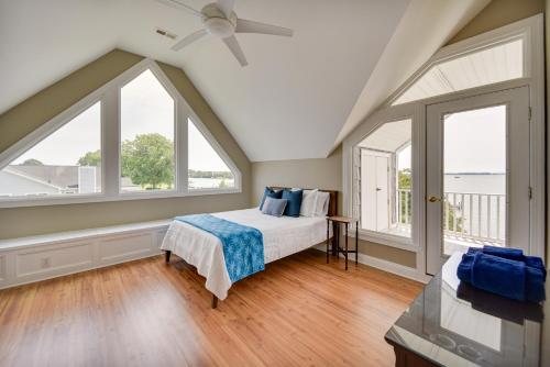 a bedroom with a bed and large windows at Gloucester Point Vacation Rental on York River! in Yorktown