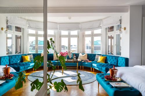 a living room with blue couches and a table at Feniks Fragola Apartments in Krakow
