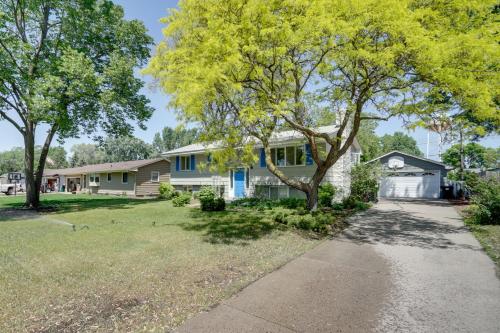 a house with a tree and a sidewalk at Pet-Friendly Minneapolis Apt Near Shops and Dining! in Minneapolis
