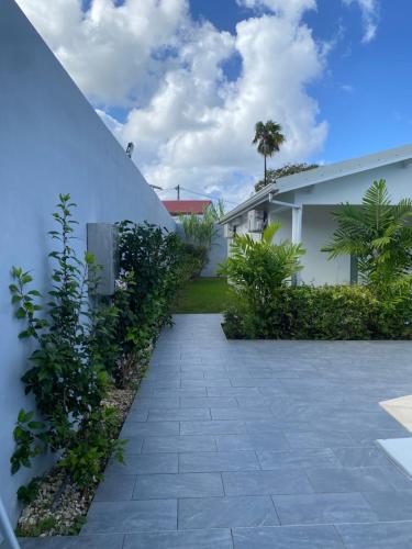 un patio de una casa con una pasarela de piedra en Villa Mircene, en Saint-Louis