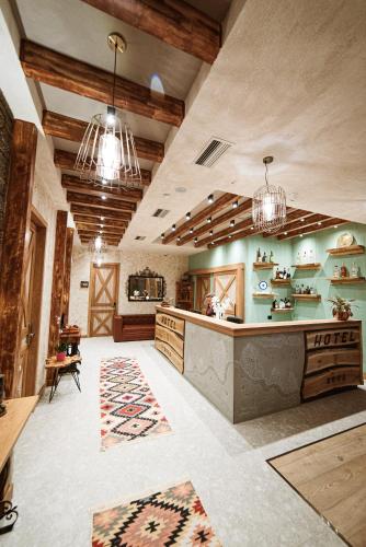 a large kitchen with a counter and some lights at Hotel Taverna Devolli in Kuçovë