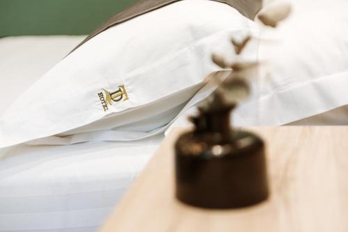a close up of a remote control on a bed at Hotel Taverna Devolli in Kuçovë