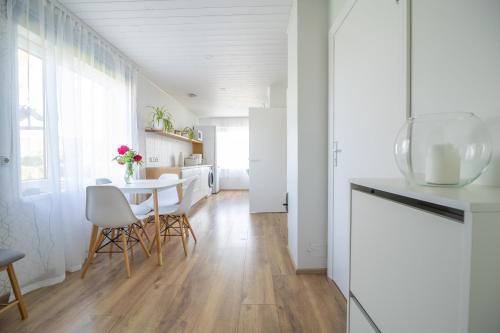 a kitchen and dining room with a table and chairs at Manni's house with garden & playground in Kuressaare