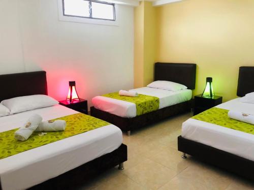 a room with three beds with lights on them at HOTEL SHAMBALA in Salento
