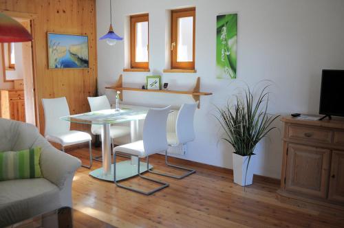 a living room with a table and chairs and a couch at Haus Eichhorn Ferienwohnung in Hermagor