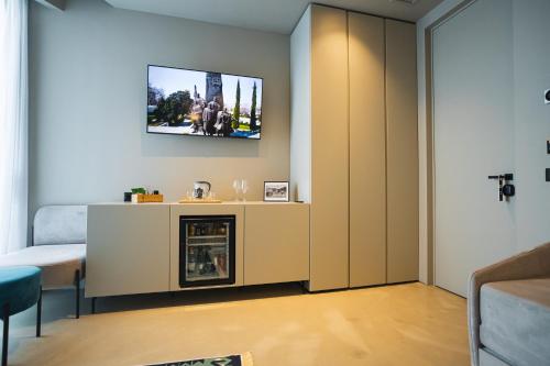 a living room with a fireplace and a tv on the wall at Dot Tradition in Vlorë