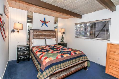 a bedroom with a bed in a room at Lakefront Cottage - Trip Advisor Certificate of Excellence winner with gorgeous lake views! in Big Bear Lake
