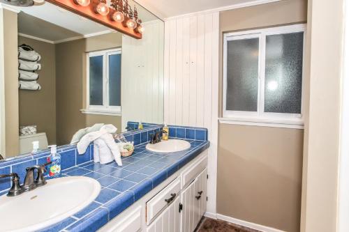 a bathroom with two sinks and a mirror at Lakefront Cottage - Trip Advisor Certificate of Excellence winner with gorgeous lake views! in Big Bear Lake