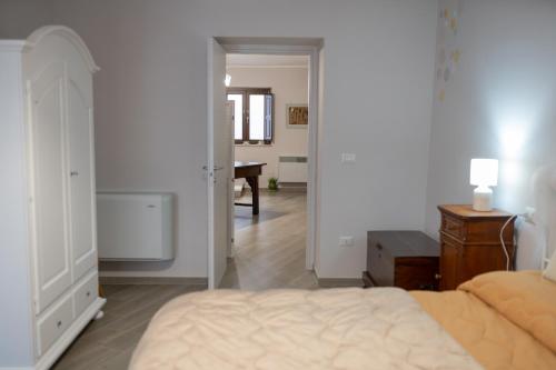 a bedroom with a bed and a hallway with a desk at B&b Antica Dimora in Chiaromonte