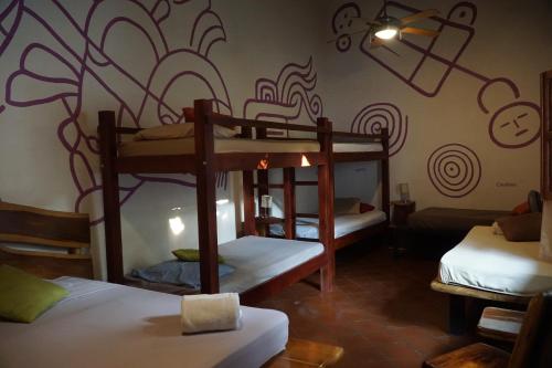 a room with three bunk beds in it at Cueva Nica in Granada