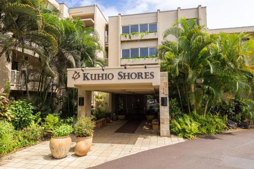 a building with a sign that reads kaito stores at Kuhio Shores 107 in Kukuiula