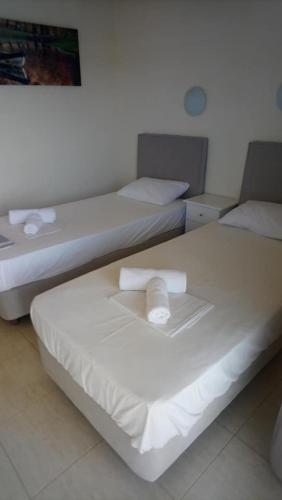 two twin beds in a room with at Vergina Pension in Sarti